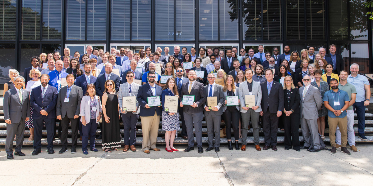 Large group of people stand on steps for photo 