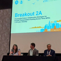 Three panelists talking at conference