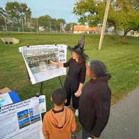 CMAP staff dressed in halloween costumes engage with Maywood residents