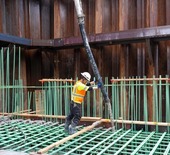 Construction worker pouring concrete
