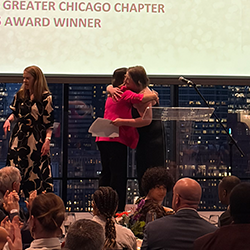 CMAP staff member hugging award winner