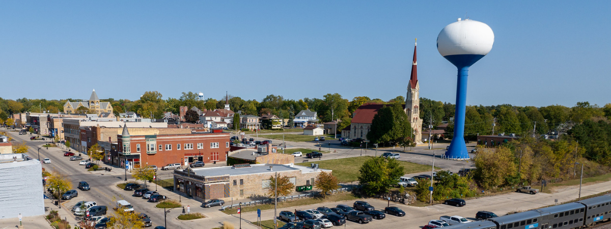water tower next to church and other buildings