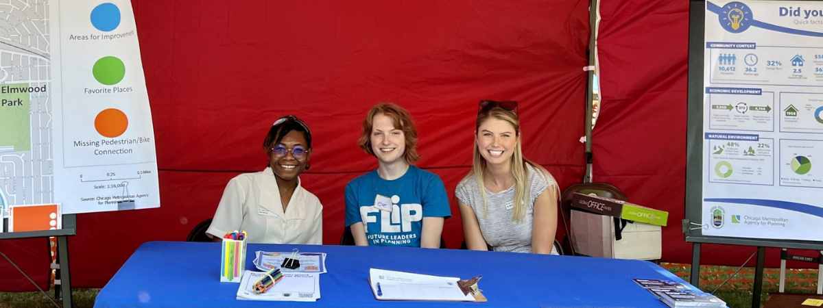 Three people sit behind CMAP table near posters about River Grove