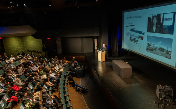 Mayor Andrew Goczkowski addresses a room full of local business owners 