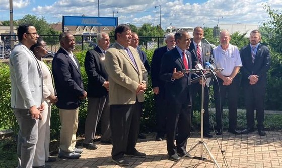 Board members Sam Tornatore and Greg Schwarze attend a press conference to oppose the proposed merger of two railroads.
