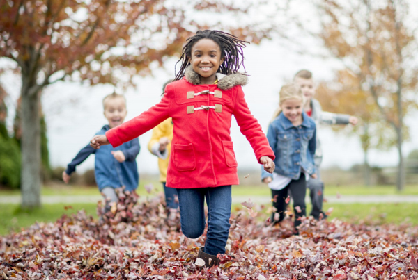 Children playing in fall leaves