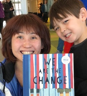 mom and son holding books -cropped