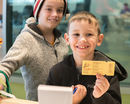 Two boys holding library cards