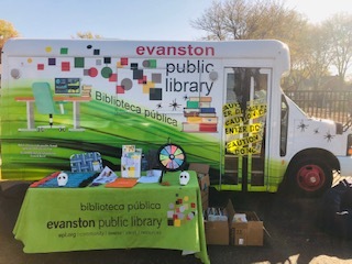 EPL mobile library van with a table set up in front for display