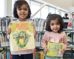 2 girls holding books