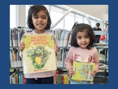 2 girls holding books with blue background