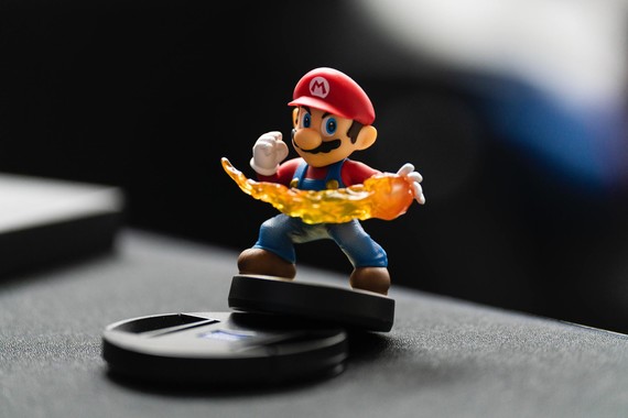 A Mario figurine with a fire-bomb in hand.