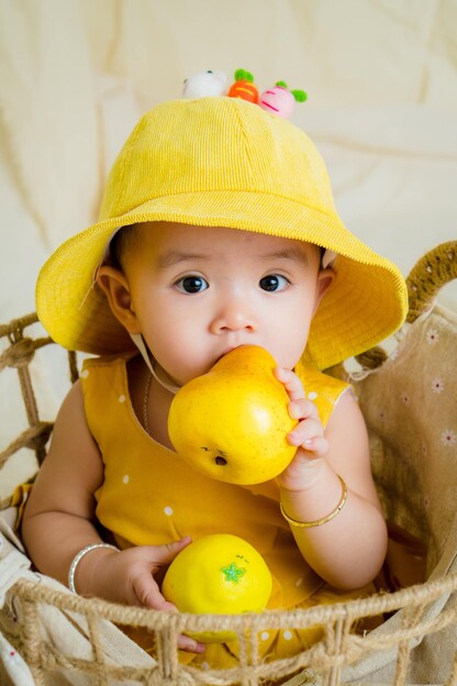 baby in yellow shirt