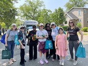 People standing in front of EPL bus at Juneteenth parade