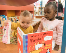 two young children looking at books