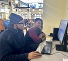 patron charles and librarian Elacsha working at a computer together