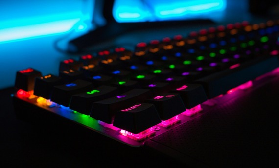 computer keyboard with rainbow neon underlighting