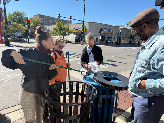 City staff picking up trash on the sidewalk