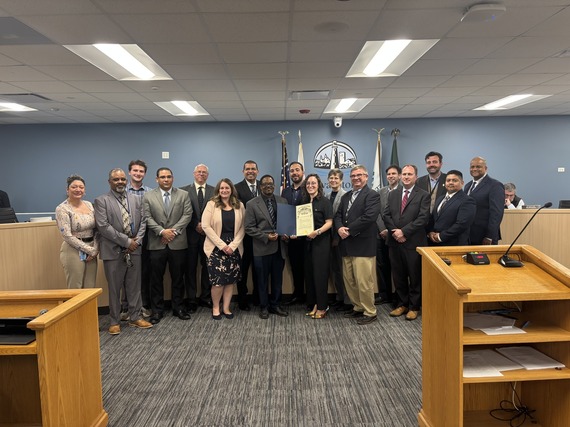 Staff posing with proclamation for Public Service Recognition Week