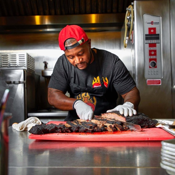  Owner of Soul & Smoke cutting meat
