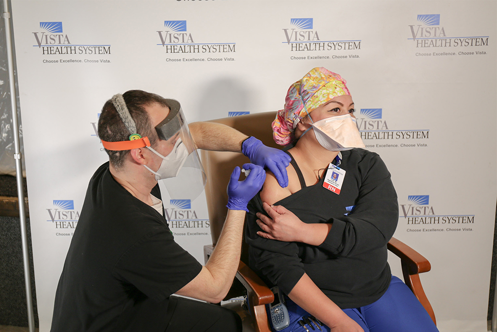 Luz Movido, RN at Vista Medical Center East receives one of the first COVID-19 vaccinations in Lake County