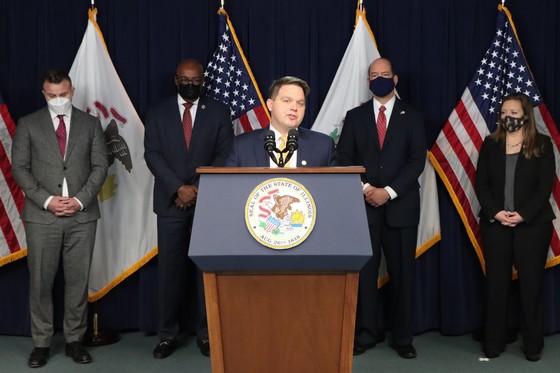 Lake County State's Attorney Eric Rinehart at podium speaking during Opioid Settlement Press Conference with AG Raoul and State's Attorneys in back