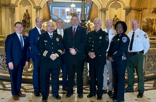 Group of people, including law enforcement officers