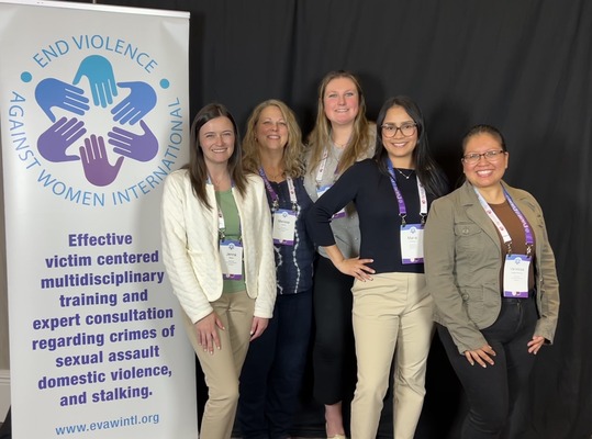 Group of five women in business casual attire
