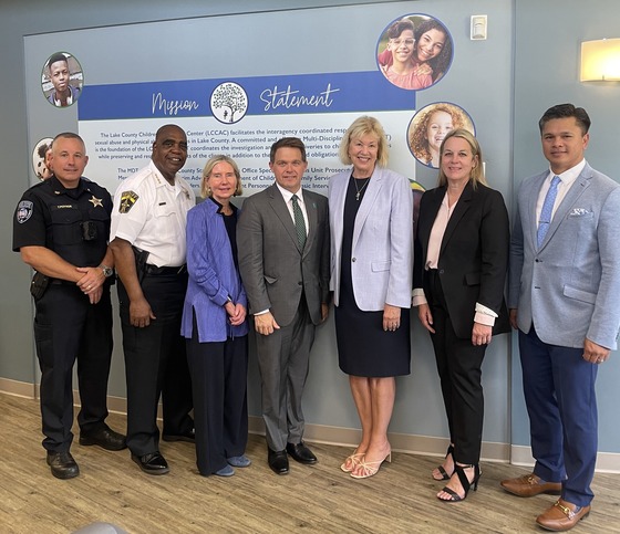 Two law enforcement officers and four people dress in business attire