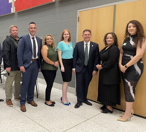 Seven people dressed in formal business attire