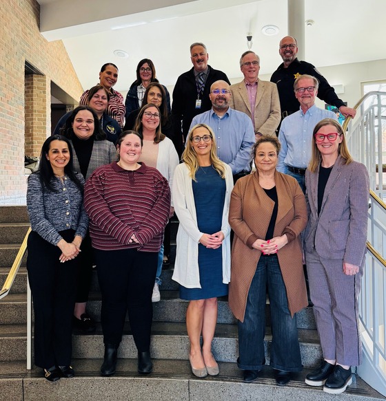Group of people standing on a flight of stairs in business casual attire