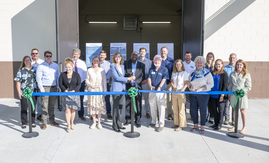 Attendees taking photos at the ribbon cutting