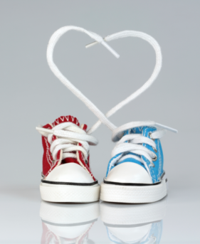 Baby shoes with laces forming a heart shape