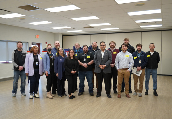 The Voter Experience event group photo of all the staff involved, in front of voter booths.