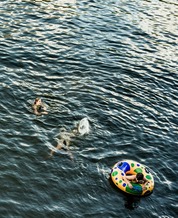 Lake with people floating on tubes