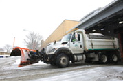 Snow plow leaving Public Works Center
