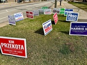 Political yard signs outside Village Hall