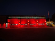 Main fire station with red lights for Fallen Firefighters Week