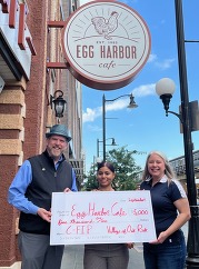 Cam Davis and Emily Egan presenting C-FIP check to Egg Harbor