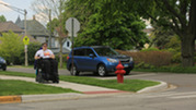 Person in wheelchair crossing street - Disability access example