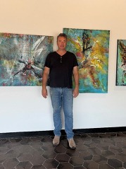 Artist Rick Sullivan in front of his artwork at Village Hall