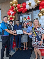 Village President Vicki Scaman at a ribbon-cutting ceremony at Wing Snob