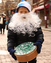 Kid with cookie tin during Downtown Oak Park Winterfest and Cookie Walk in 2024