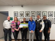 Police and Neighborhood Services staff receiving holiday gift from Way Back Inn