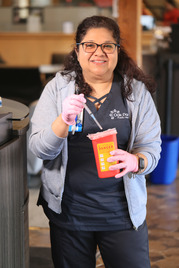 Public Health Nurse Betty Arguezo-Gonzalez with the Village's sharps collection container.