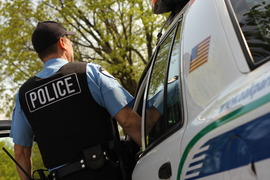 Oak Park Police Officer outside squad car on street - demonstrating vacation watch