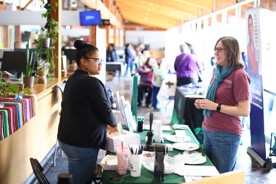 Village Clerk Christina Waters speaks with a participant at the 2025 Civic Engagement Festival at Village Hall