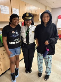 Police Chief Shatonya Johnson stands with two students 