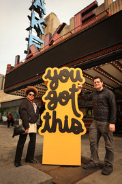 Arts Council Director Camile Wilson-White and artist Matthew Hoffman with Hoffman's sculpture outside Lake Theatre.
