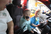 Kids check out Village-owned vehicles at the Public Works Center